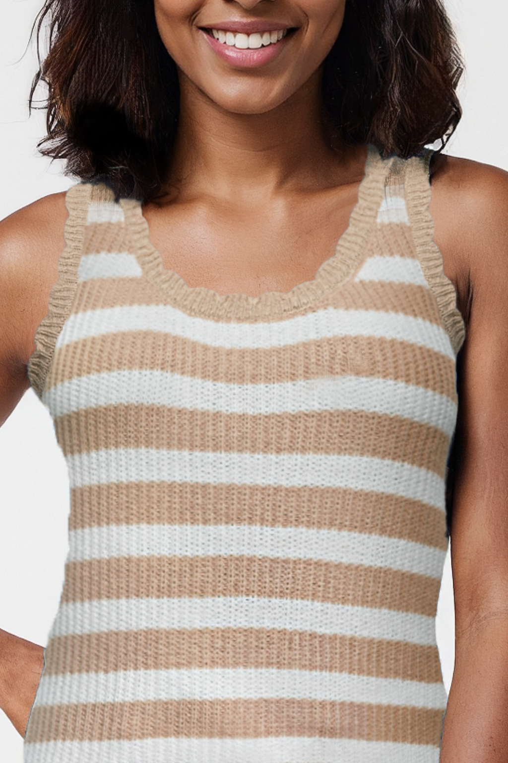 Woman wearing a beige and white striped sleeveless top against a plain background. #color_tuffet-colette-stripe