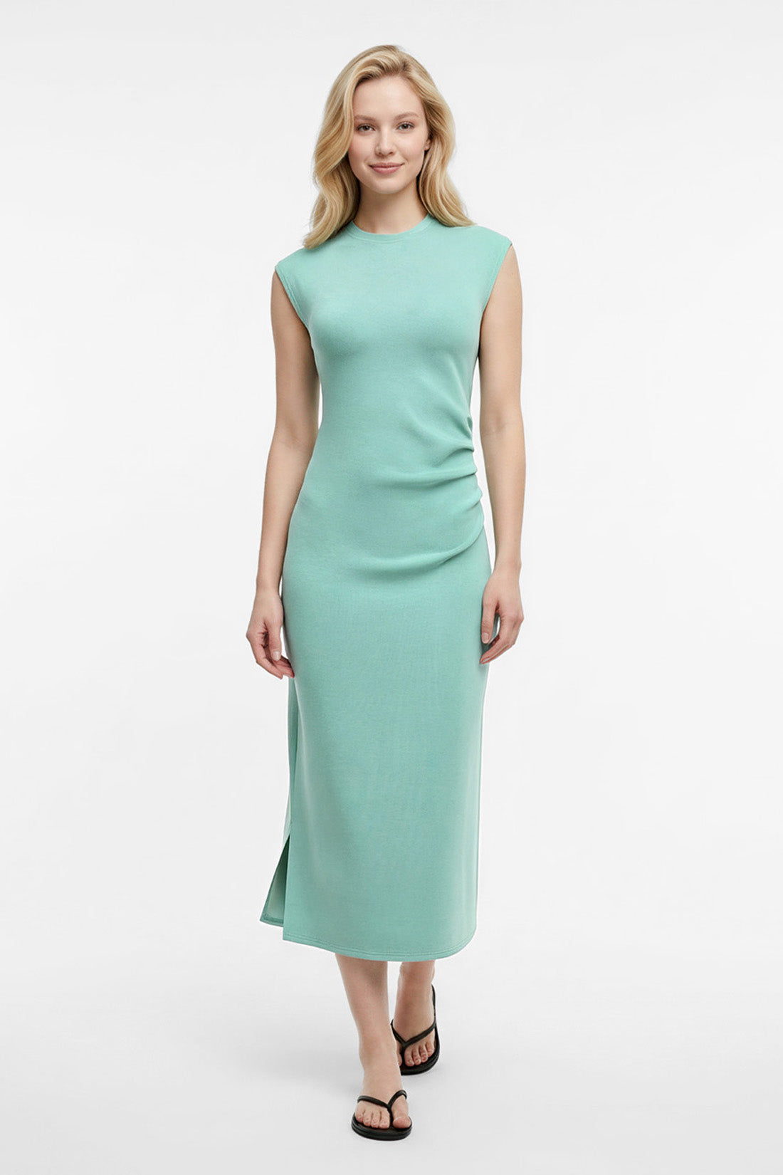 Woman wearing a light blue dress on a white background. 
