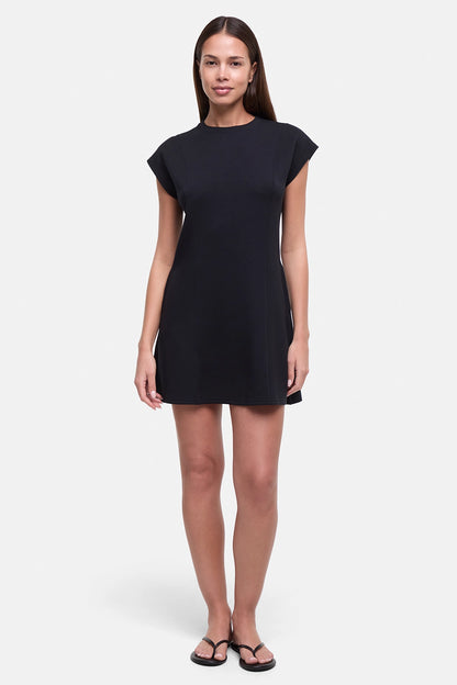 Front view of woman wearing a black mini dress on a white background.