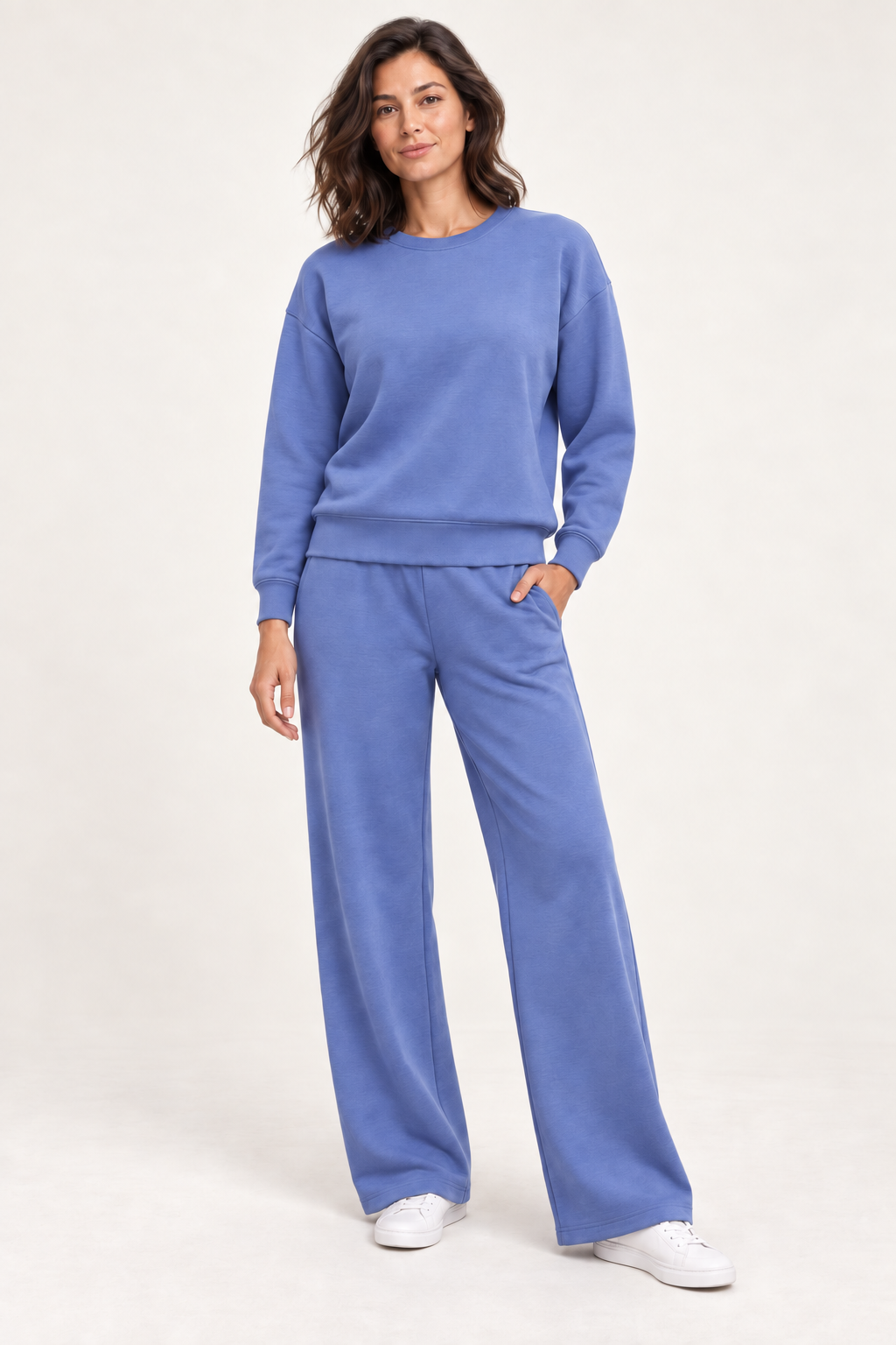 Woman wearing the blue Lana Pullover and matching wide-leg pants, front studio view
