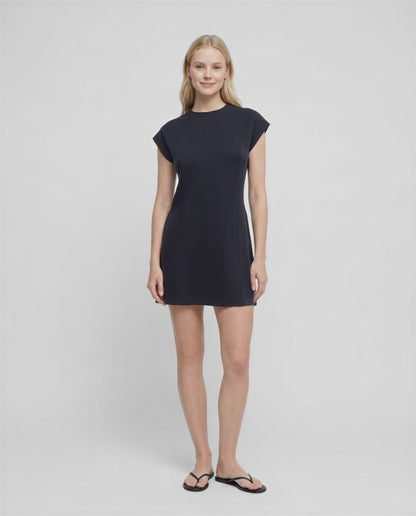 Video view of woman wearing a black mini dress on a white background.