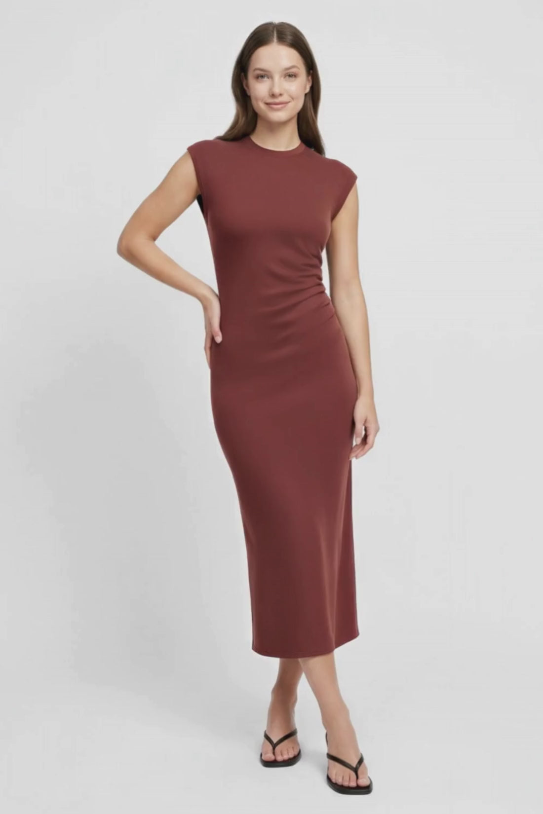 Video view of Woman wearing a brown dress on a white background. 