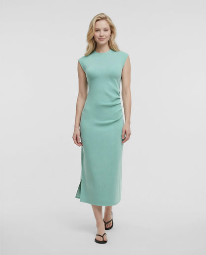 Video view of woman wearing a light blue dress on a white background. 