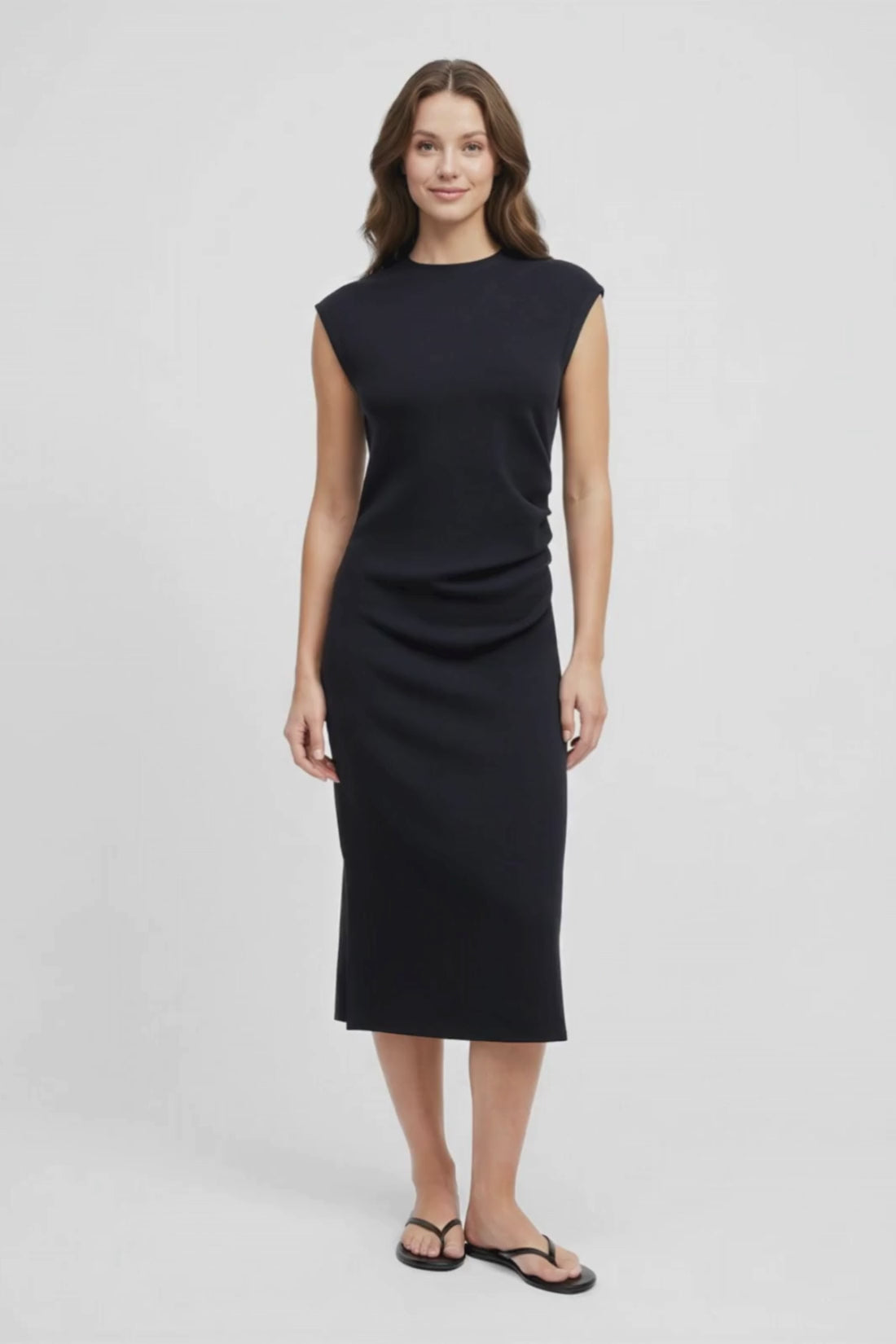 Video view of woman wearing a black sleeveless dress on a white background. #color_black-beauty